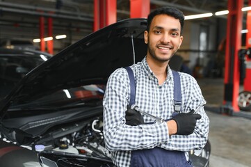 Indian happy auto mechanic in blue suit.