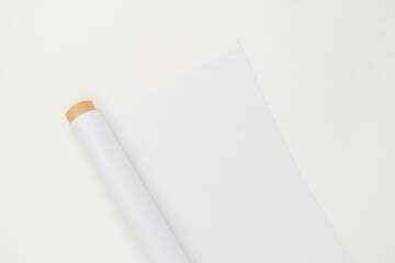A mockup image featuring a fabric roll placed in a minimalistic setup is shown