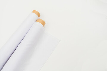 A minimalistic setup highlights a mockup image of a fabric roll