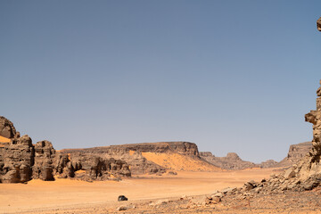Fototapeta na wymiar view in the Sahara desert of Tadrart rouge tassili najer in Djanet City ,Algeria.colorful orange sand, rocky mountains 