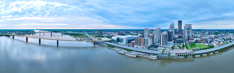 Wide view downtown Louisville KY US panorama aerial Ohio River waterway, boats, and bridges