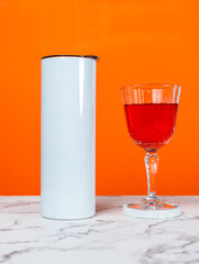 Effortlessly chic, a mockup image captures the essence of understated luxury with a white blank tumbler in a wine-themed setup