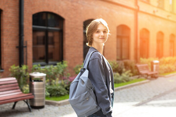 Back to university. The girl goes to the university, studies, the girl with a backpack and a folder. High school student. College. Student.