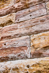 Vertical wall of rustic gold and yellow bricks background asset