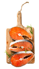 Fresh raw salmon steaks on wooden board. Top view of fish.