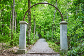 White stone, rock arch bases with rusty iron metal arches, portal archway