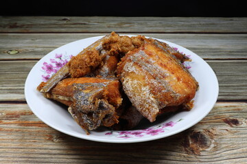 Pile of deep fried Cutlass fish (Largehead Hairtail) serving on the plate. Famous crispy and crunchy seafood menu in Asia restaurant.