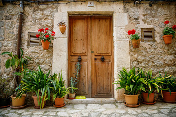 Fototapeta na wymiar Beautiful cozy and flower-adorned entrance to a typical house in Valldemossa, Mallorca