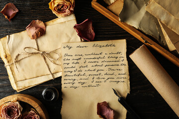 Vintage letters, letter with text and rose petals on wooden background, top view - Powered by Adobe