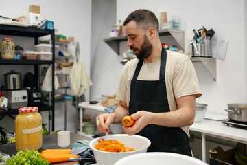Fototapeta na wymiar Young chef peeling carrots