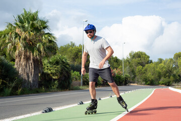 Man practising inline skating on a bike lane.