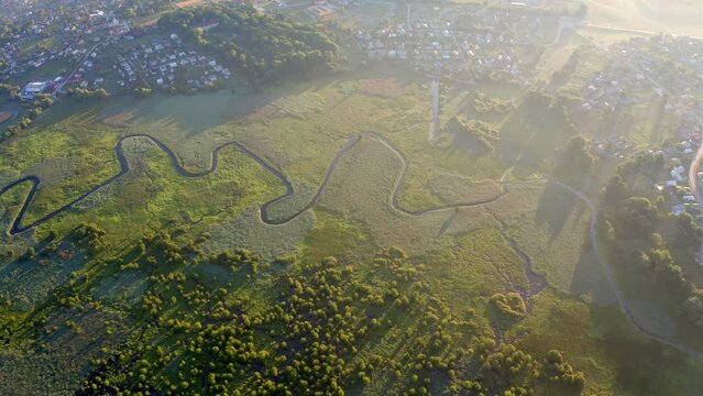 4k drone flight up footage (Ultra High Definition) of flooded valley. Misty morning scene of snake shape Seret river. Wonderful sunrise on Ternopil countryside, Ukraine, Europe.