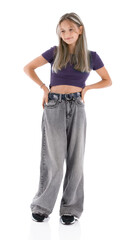 Full length portrait of akimbo pretty girl isolated on white background. Beautiful teenager in violet T-shirt looking to the side and smile, posing in studio.