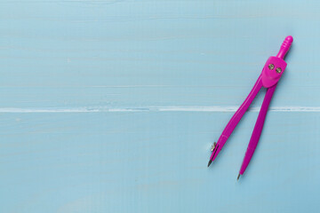 Divider on wooden backgroung, top view