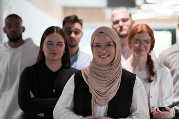 A group of young business professionals stands together, taking a well-deserved break from their busy workday, showcasing camaraderie, teamwork, and a moment of relaxation in their dynamic workplace