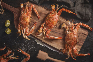 Three boiled crabs on a wooden cutting board - top view © Mohamed