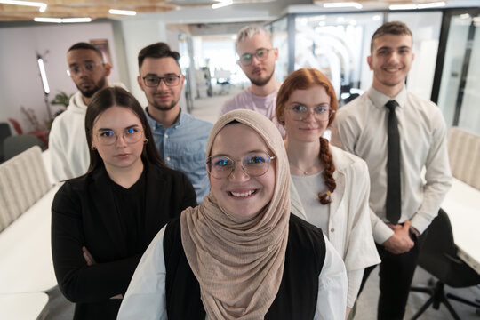 A Group Of Young Business Professionals Stands Together, Taking A Well-deserved Break From Their Busy Workday, Showcasing Camaraderie, Teamwork, And A Moment Of Relaxation In Their Dynamic Workplace