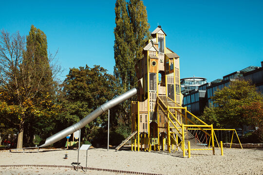 Modern Children's Playground For Outdoor Games, A Slide Pipe Made Of Metal, Pyramids Made Of Wood, Rubber Coating On The Playground. Children's Playground, Spiral Slide Pipe, Amusement Park, Modern