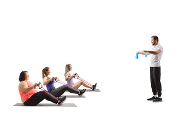 Male trainer and women exercising with a resistance bands
