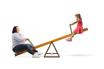 Overweight woman playing on a seesaw with a little girl