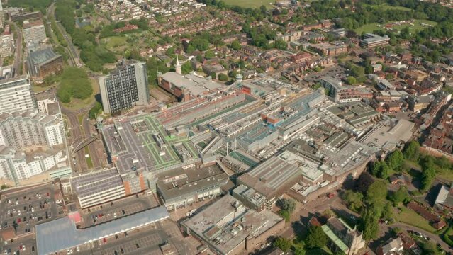 Circling aerial shot over Basingstoke central mall with parking lots on top