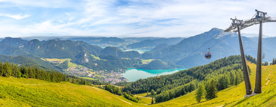 Landscape with cable car, lake Wolfgangsee and mountain Schafberg, view from the mountain Zwolferhorn - Powered by Adobe