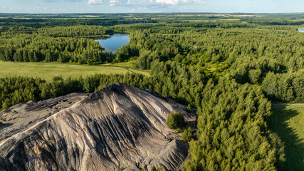 panoramic view of the high hills of the lake with turquoise water and green forest from the reserve in the Tula region taken from a drone