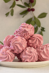 Obraz na płótnie Canvas Cherry pink zephyr summer dessert on a light background