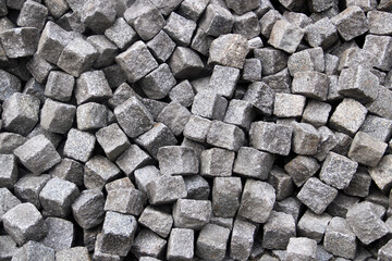 Pile of cobblestones on a pavement, a construction background