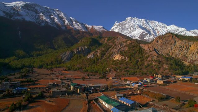 Aerial establishing shot Humde village house buildings.Guesthouses in Annapurna circuit trek. Marshyangdi valley. Himalayas mountain range. Nepalese house buildings architecture. 