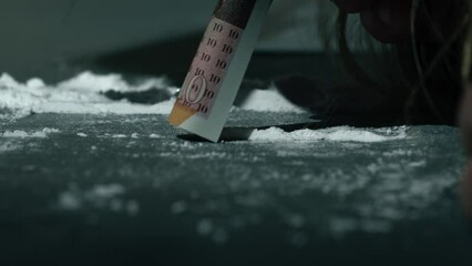 Drug addict snorting line of cocaine