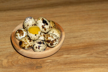 quail eggs in wooden bowl.