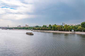 Fototapeta premium Cruise ship sails on the Moscow river in Moscow city center, popular place for walking.