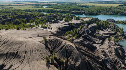 panoramic view of the high hills of the lake with turquoise water and green forest from the reserve in the Tula region taken from a drone