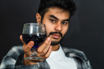 Embrace the art of wine appreciation as a young man showcases his drink, creating an inviting...