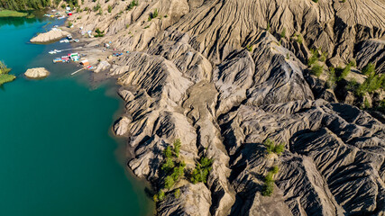 panoramic view of the high hills of the lake with turquoise water and green forest from the reserve in the Tula region taken from a drone