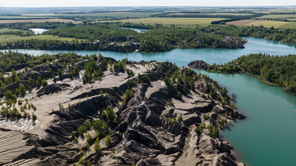 panoramic view of the high hills of the lake with turquoise water and green forest from the reserve in the Tula region taken from a drone
