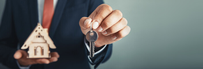 man hand key with house model