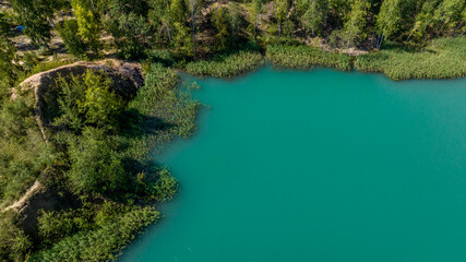 panoramic view of the high hills of the lake with turquoise water and green forest from the reserve in the Tula region taken from a drone