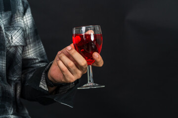 With a touch of elegance, an image presents a young man gracefully displaying his wine drink