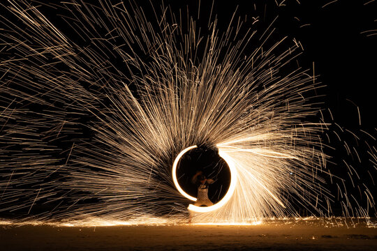 Sparks swirling on the beach at night party beach.