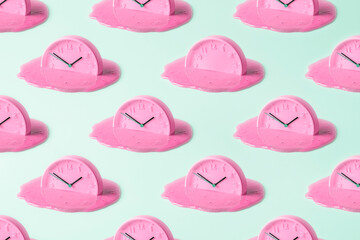 Creative concept of time. Pink clock pattern on turquoise background.