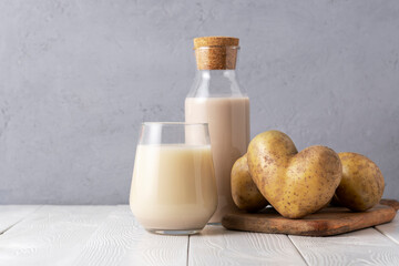Glass of potato molokan on the table with heart-shaped potatoes.