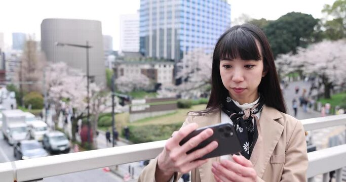 A portrait of selfie by Japanese woman behind cherry blossom 