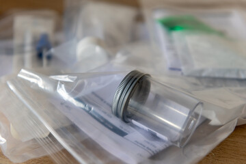 A pile of sample containers and request forms for medical test.