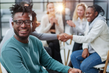 Obraz premium Gathered happy young businessmen holding negotiations, meeting with friendly diverse colleagues