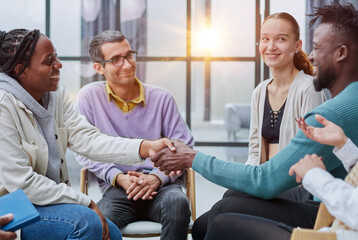 close up. smiling guy shaking hands with his friend