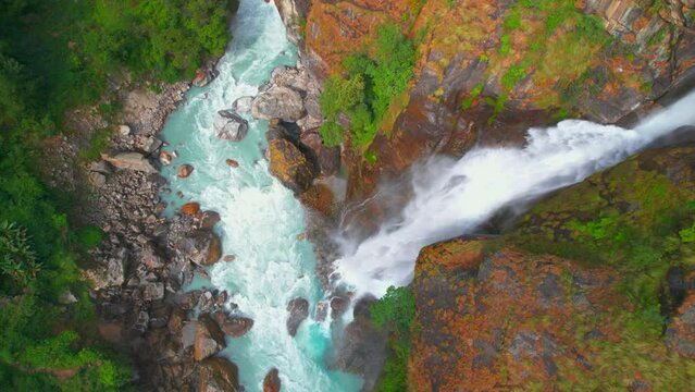 Aerial close up establishing shot powerful Chyamche waterfall and water river stream. Way to Manang sightseeing spots. Annapurna circuit trek. Lamjung.