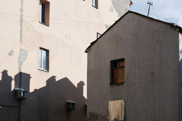 Facade of an abandoned house with boarded up windows
