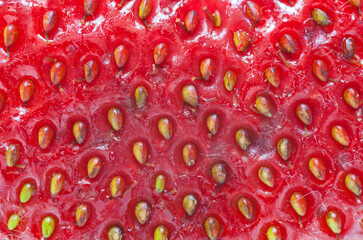 Close-up of surface of ripe strawberry. Healthy vitamin organic fresh products. Bright summer fruit background. Can be used in advertisements for fruit cosmetics. Flat lay, macro, top view, mockup